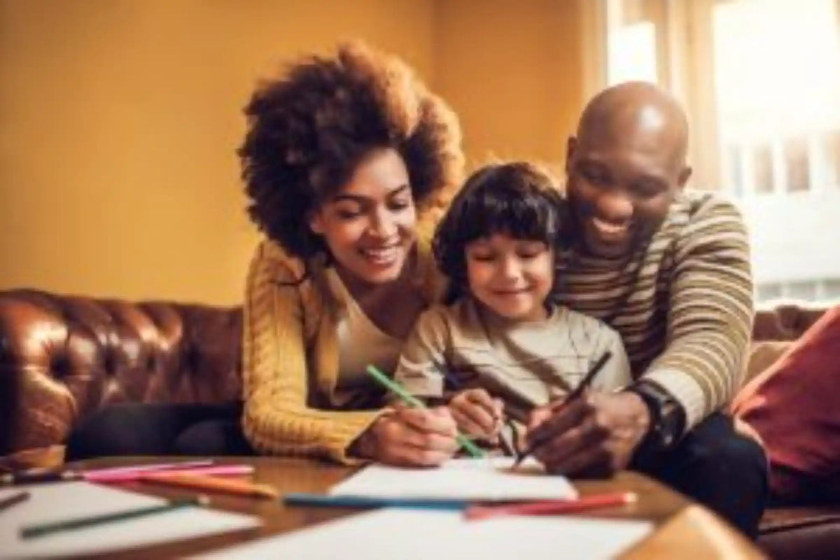 Parents helping their child with homework at a table celebrating learning and academic achievement together at home.