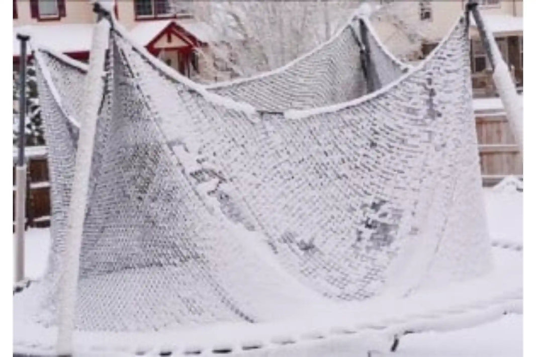 Snow-covered trampoline with a safety enclosure sagging under the weight of accumulated snow during winter weather.