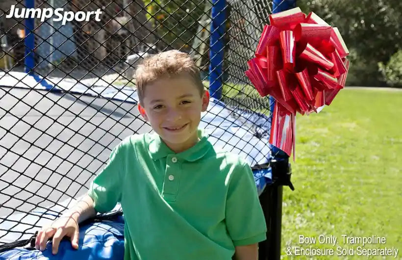 A boy posing in front of his new AlleyOOP trampoline. Our Trampoline Gift Bow is perfect for that special surprise. 